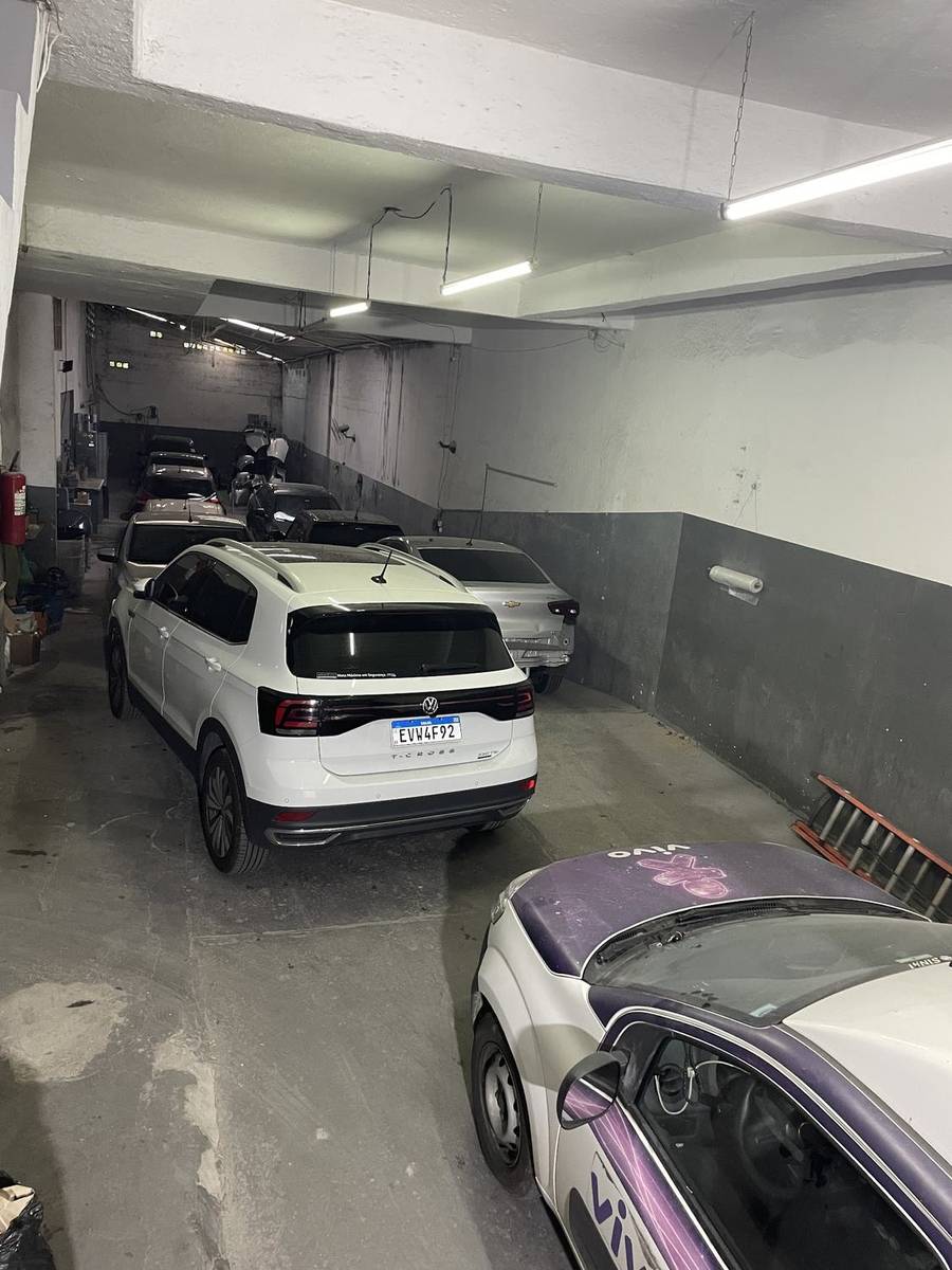 Interior do galpão da Jcar com vários carros estacionados lado a lado.